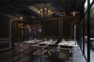 10. Restaurant Bar Elegant dining room at Nolm Cafe Restaurant with chandelier lighting and modern decor in Silom 1 2 - PASSA HOTEL BANGKOK