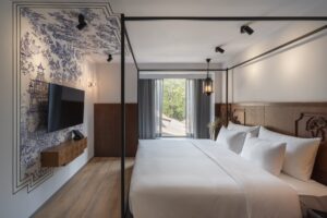 13. Room Stylish boutique hotel room in Silom featuring traditional wall art and modern comforts - PASSA HOTEL BANGKOK