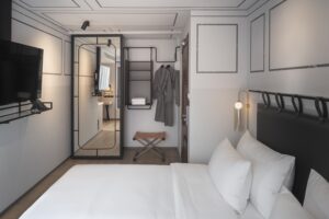 18. Room Comfortable Bangkok hotel bedroom with modern fixtures and compact design - PASSA HOTEL BANGKOK
