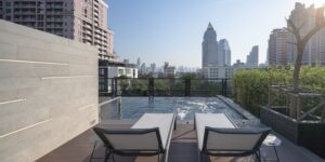 26. Facilities Modern rooftop pool oasis in Bangkok with lush greenery and sunlit cityscape views - PASSA HOTEL BANGKOK