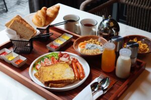 31. Restaurant Bar Deluxe breakfast set at Passa Hotel Bangkok featuring toast croissants sausages and fresh juiceJPG 1 - PASSA HOTEL BANGKOK